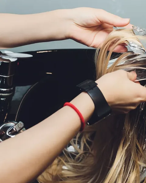 Colorist applying hair color in a Charleston, WV salon