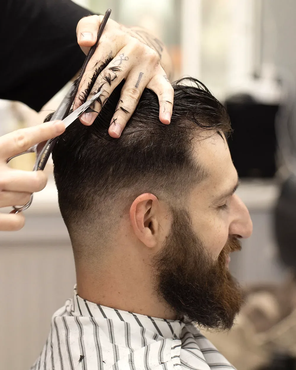 A haircut being tapered with shears at a Charleston, WV salon