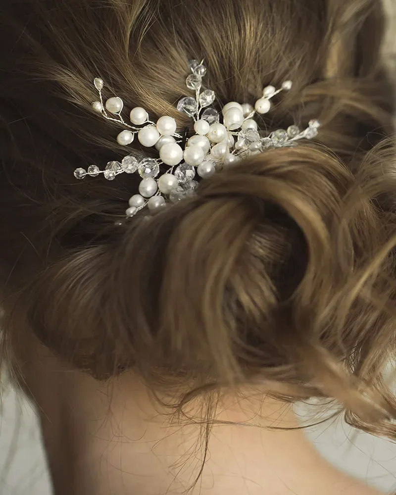 Textured bridal bun finished with a pearl hairpiece